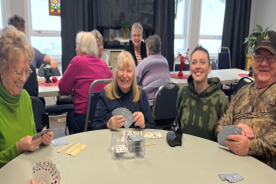 Members seated together playing games at the drop-in