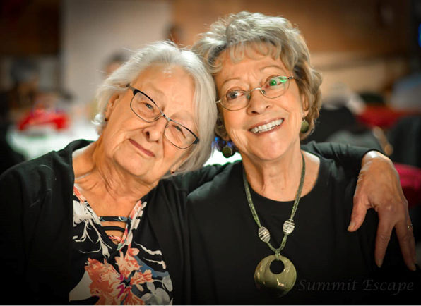 Two members smiling together at an event