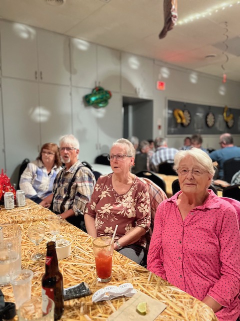 Two members chatting and visiting at a table