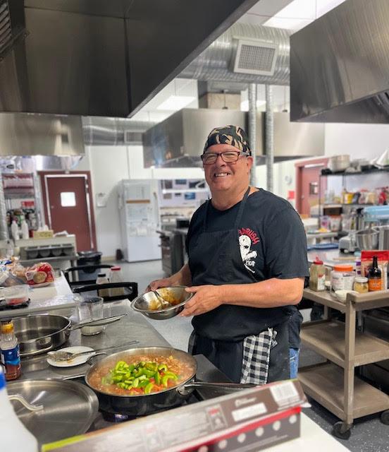 Volunteer cooking in the centre kitchen